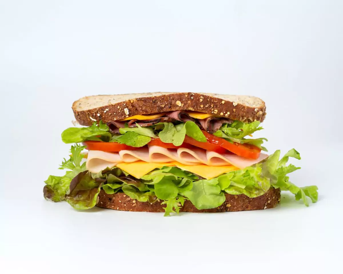 Belegtes Sandwich mit Salat, Wurst, Käse und Ei